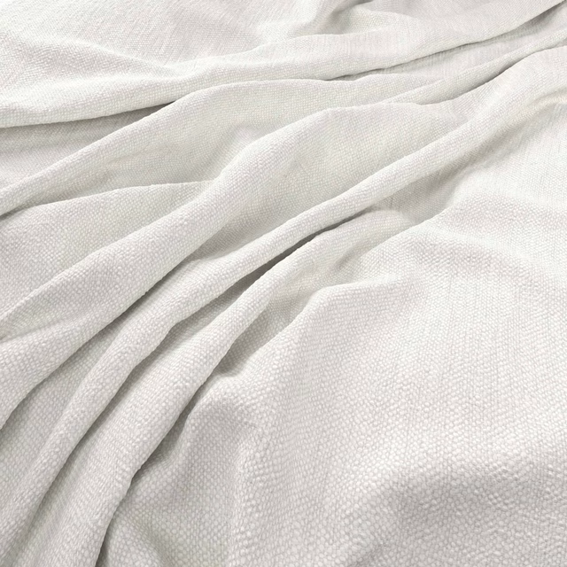 Pale ivory Parker fabric showing a fine woven texture in soft gathered folds