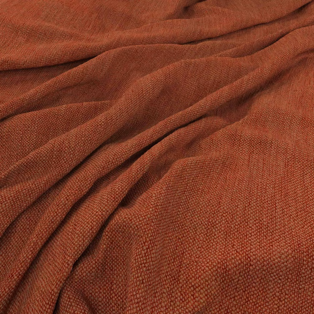 Burnt carrot-orange woven fabric gathered into folds, showing a fine pebbled texture