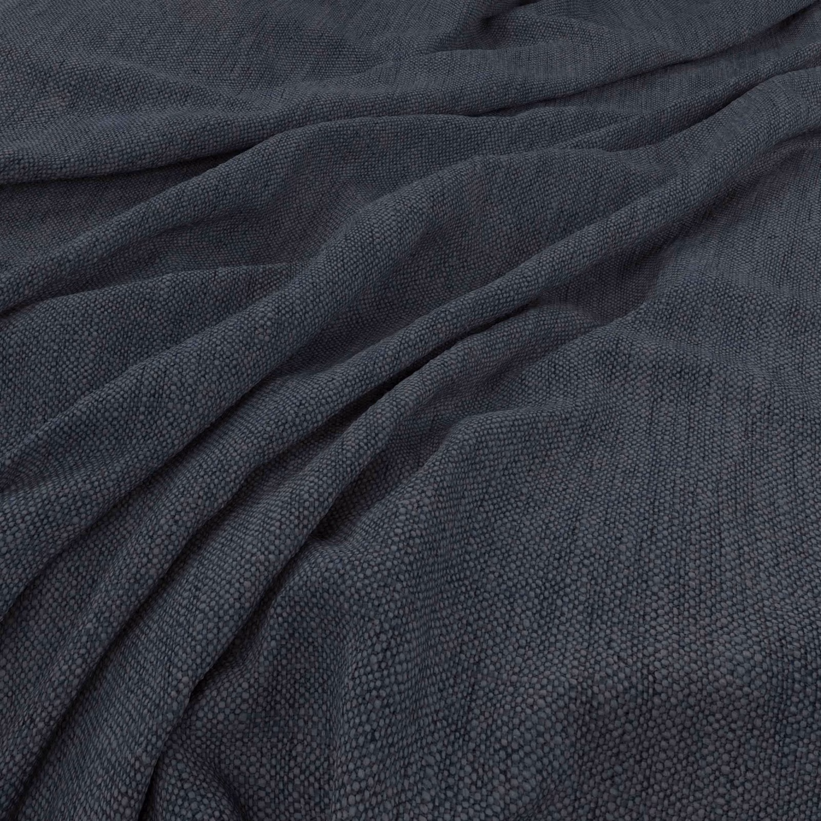 Deep indigo woven fabric with a finely pebbled texture gathered into soft folds