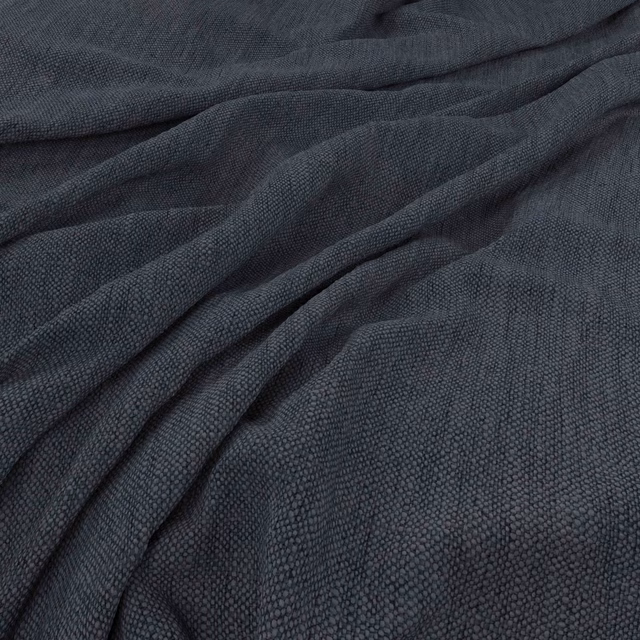 Deep indigo woven fabric with a finely pebbled texture gathered into soft folds