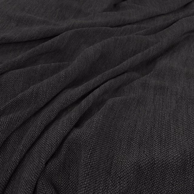 Deep charcoal-black woven fabric showing fine pebbled texture in gathered folds