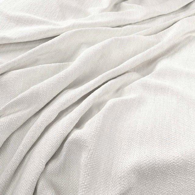 Soft optic white woven fabric with fine texture draped in gentle folds