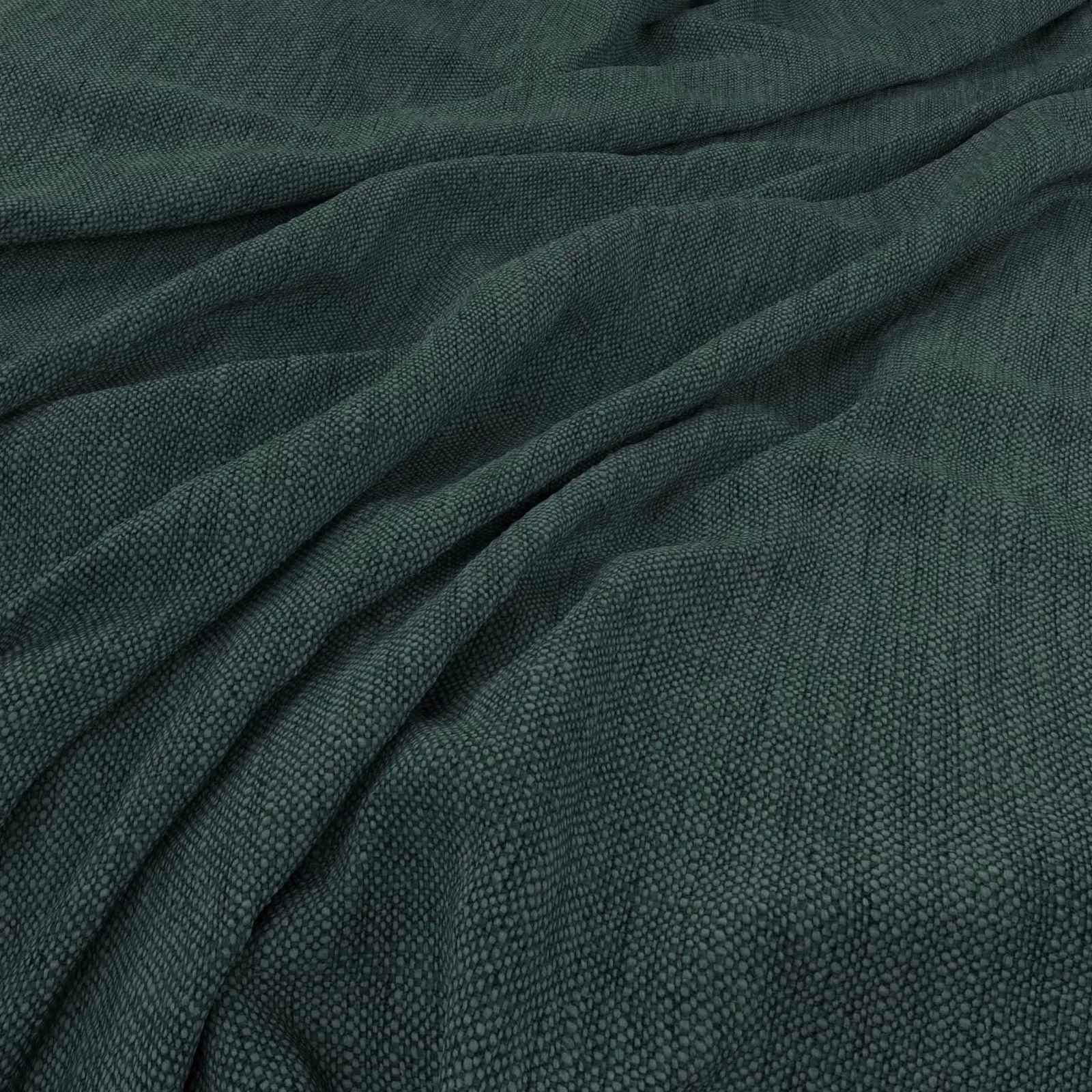 Deep pine-green woven swatch with fine pebbled texture gathered into soft folds