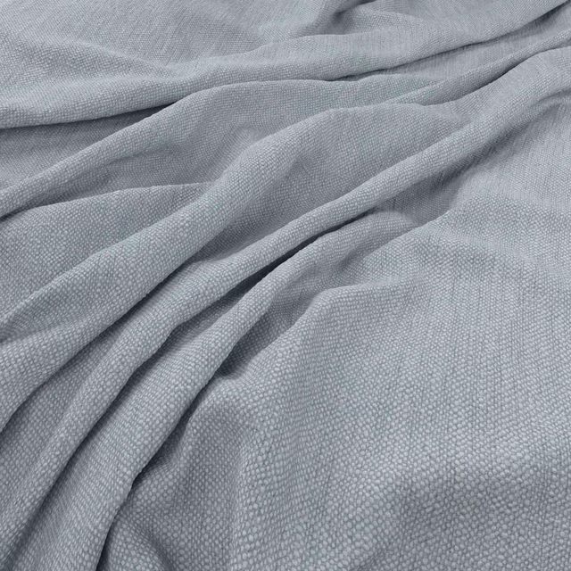Powder blue-grey woven fabric gathered into soft folds with a fine tactile texture