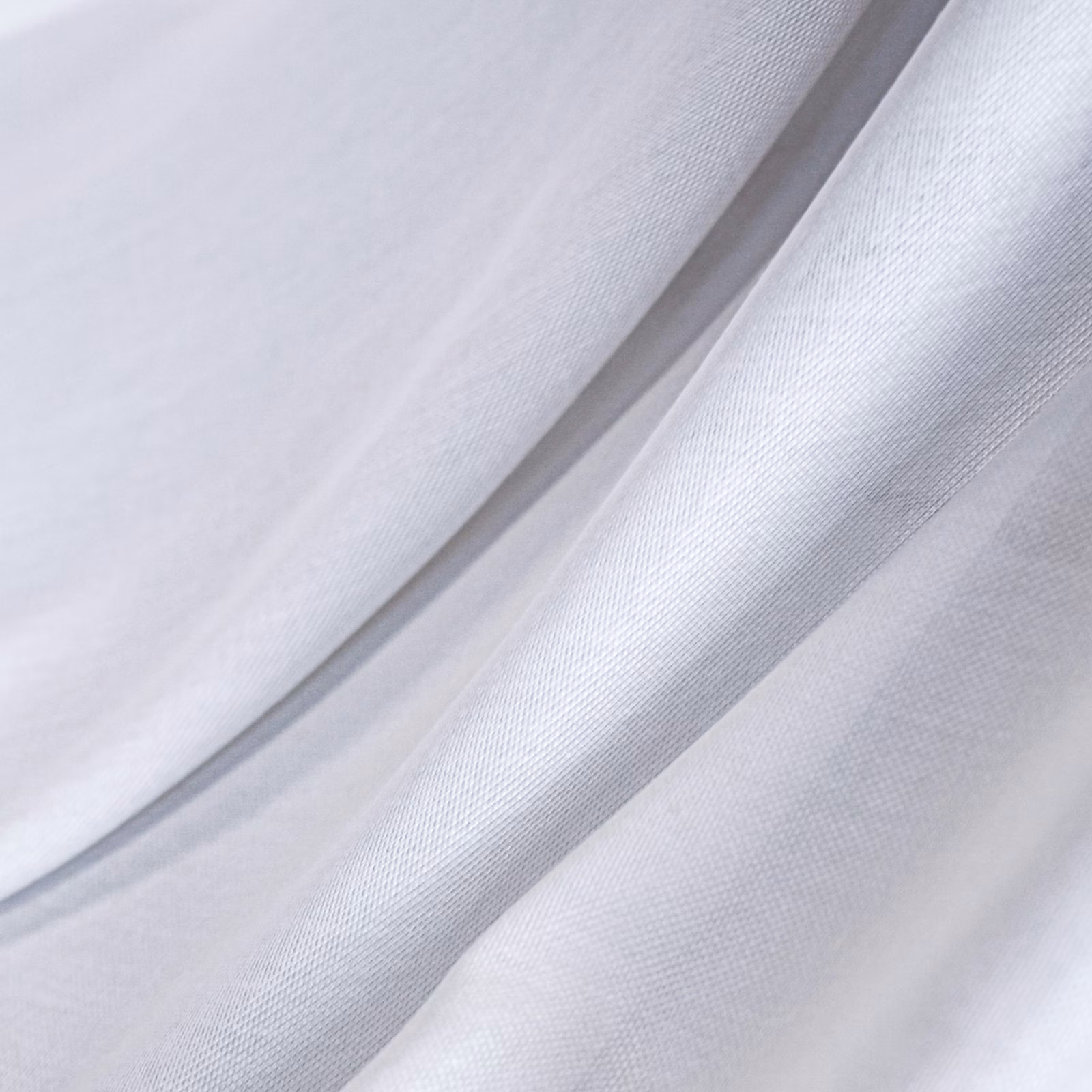 Cool white fine-weave fabric falling in softly lustrous, fluid folds