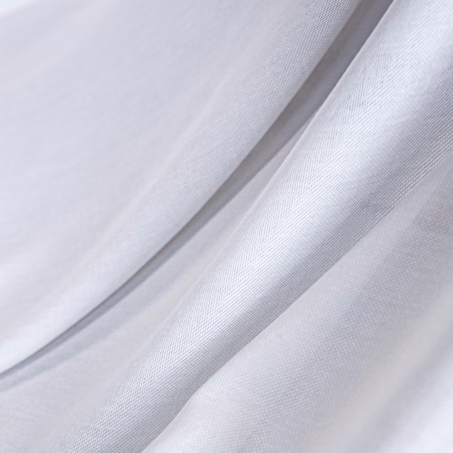 Cool white fine-weave fabric falling in softly lustrous, fluid folds