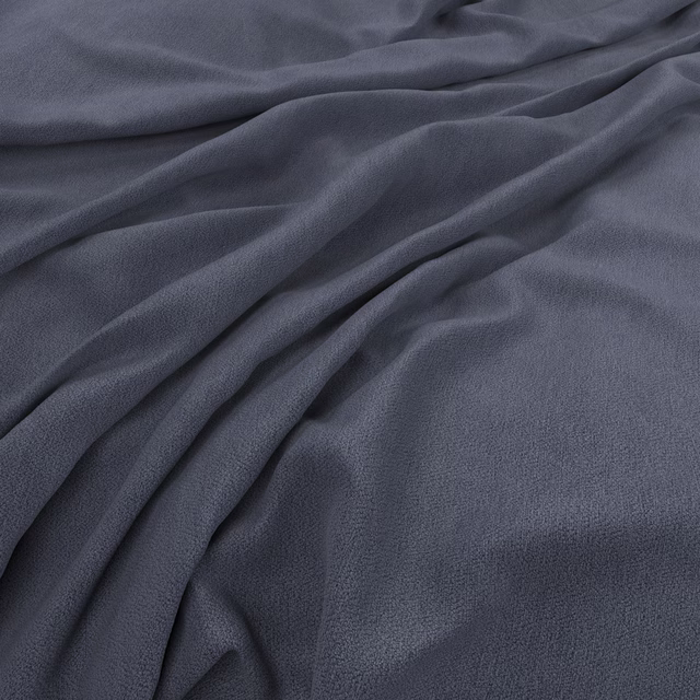 Draped muted slate-blue fabric showing a fine surface texture and soft sheen