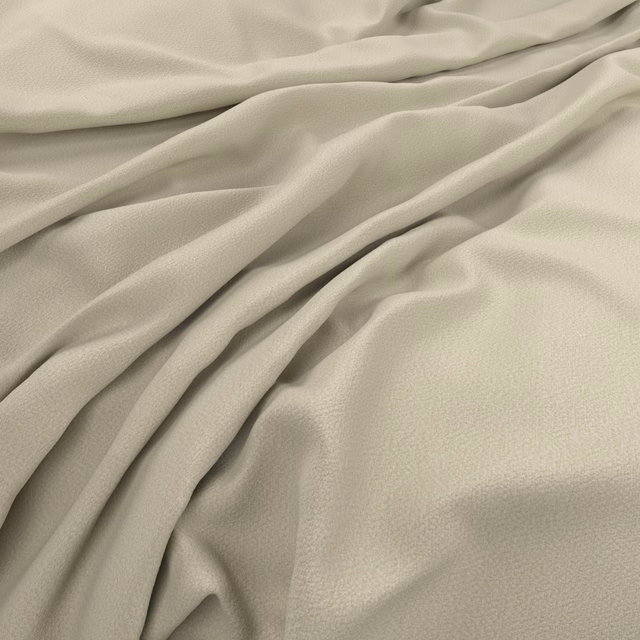 Pale peach-beige fabric draped in soft folds with a fine, subtly pebbled surface
