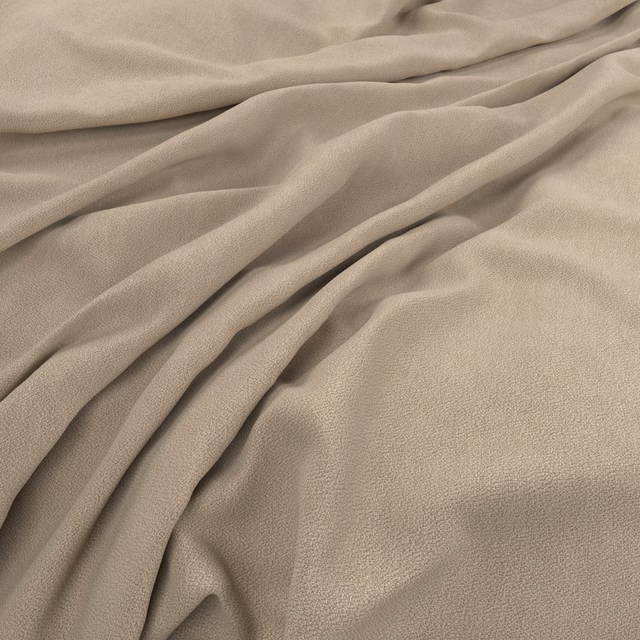 Warm peach-beige fabric in soft folds, showing a fine subtly pebbled surface