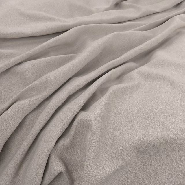 Pale peachy beige fabric with fine grain texture arranged in soft flowing folds