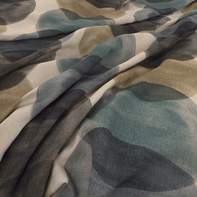 Jade, charcoal and taupe abstract forms across softly folded woven fabric