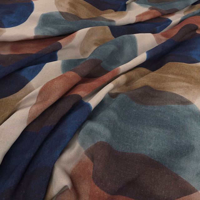 Draped textile with large muted teal, navy, rust, taupe and plum abstract shapes