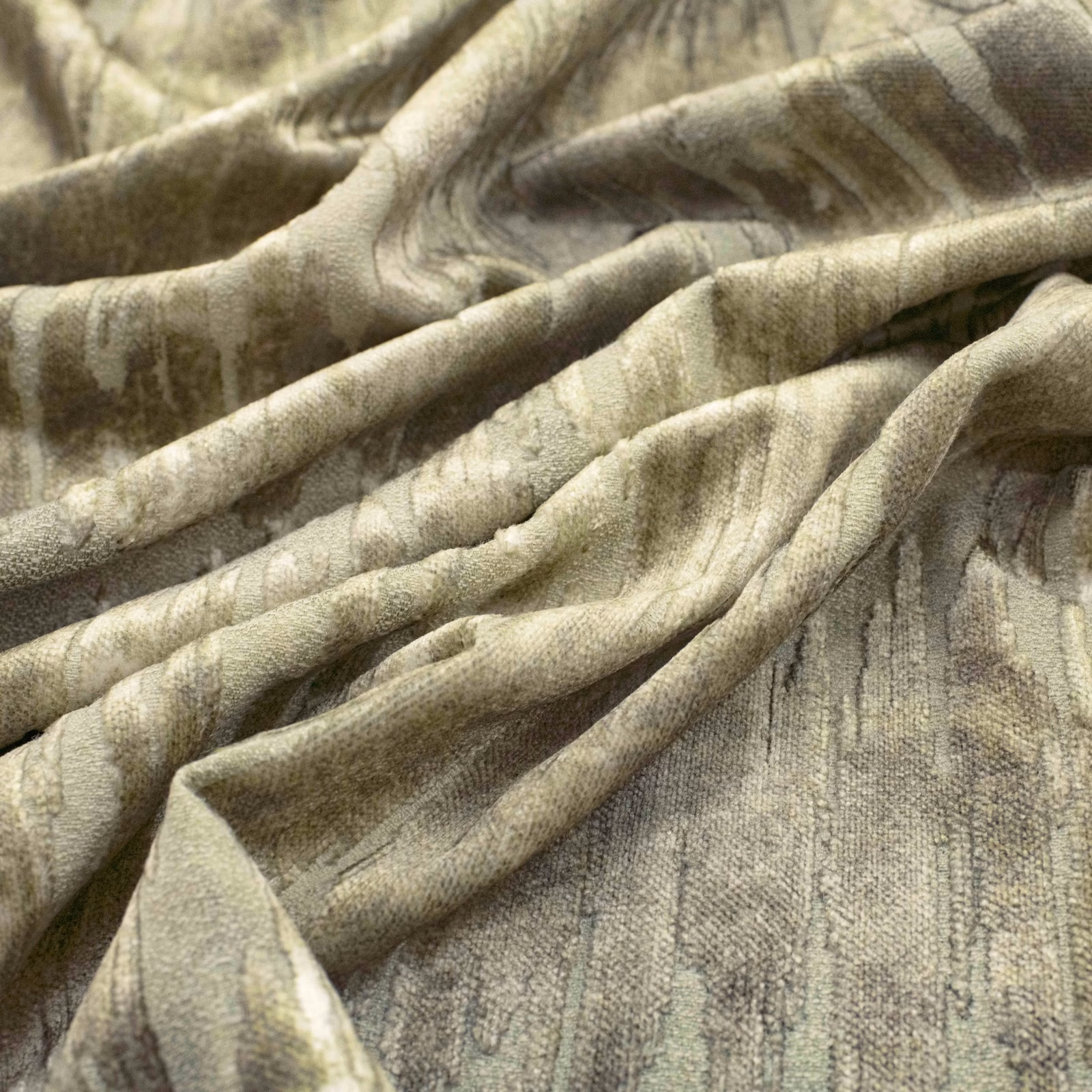 Muted olive fabric with cloudy striations and a softly napped, folded surface