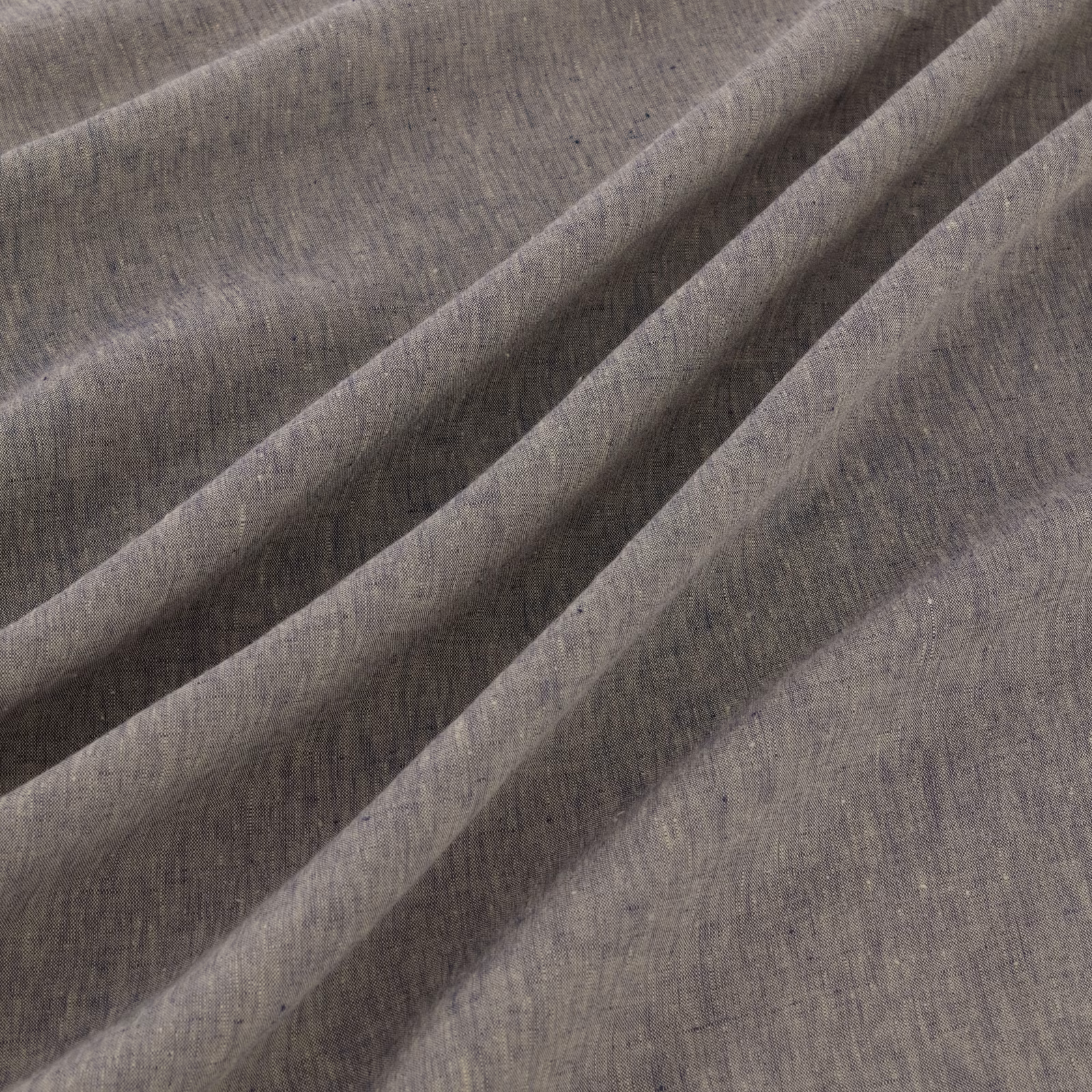 Muted denim blue-grey woven fabric with soft striations in diagonal folds