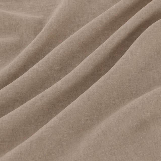 Warm pale taupe woven fabric showing fine crosshatch texture in diagonal folds