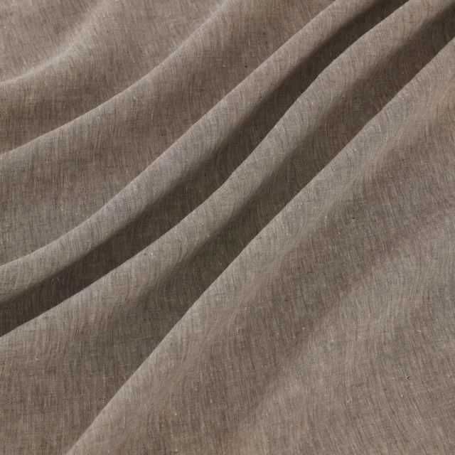 Graphite-grey slubbed textile gathered into soft, fluid diagonal folds