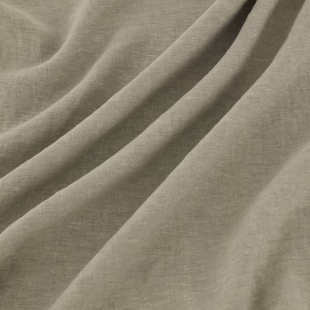 Hazy grey-taupe fabric with fine crossweave texture falling in soft diagonal folds