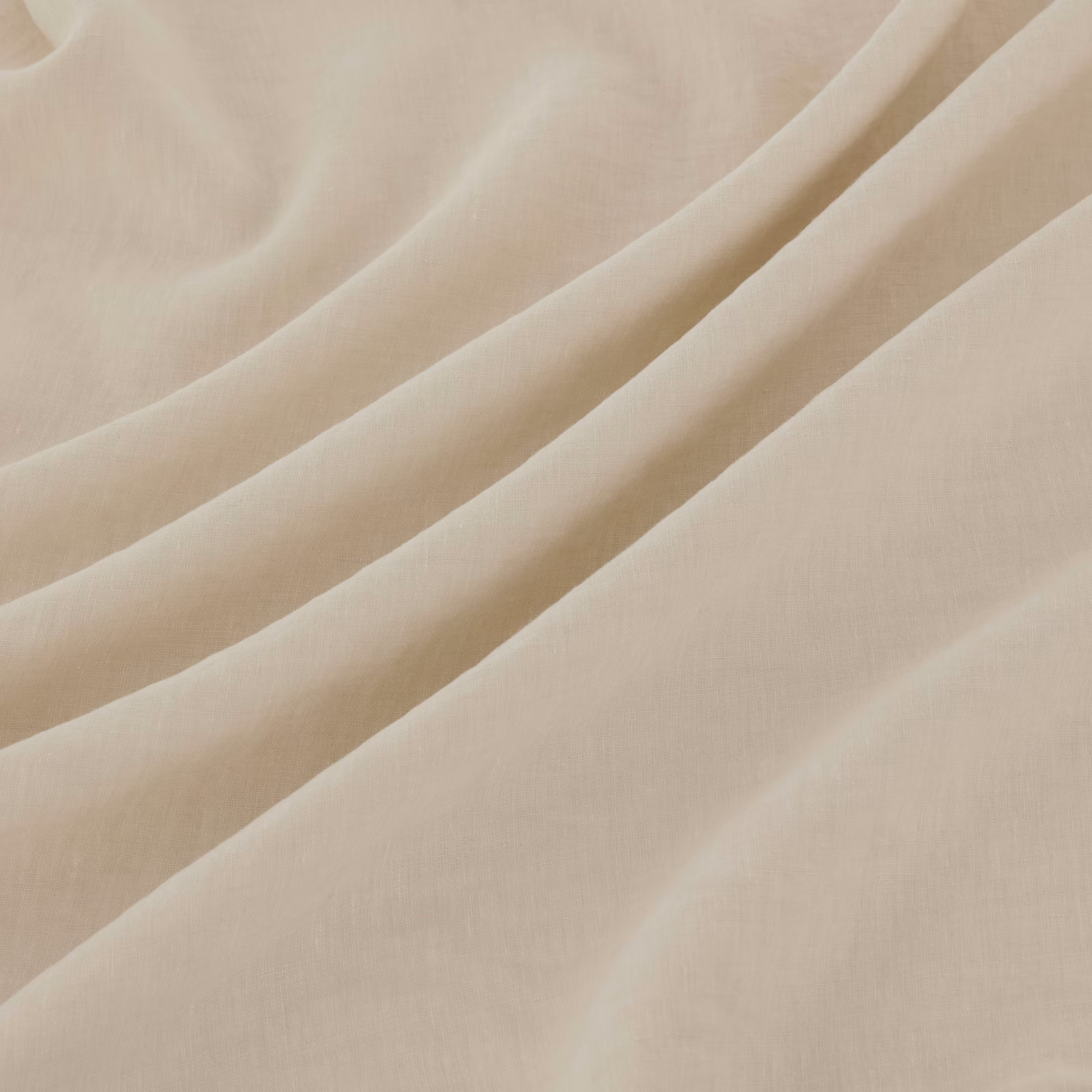 Warm ivory finely woven fabric falling in softly gathered diagonal folds
