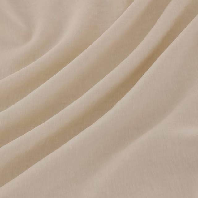 Pale milk-ivory Pesaro fabric with fine weave, shown in soft flowing folds