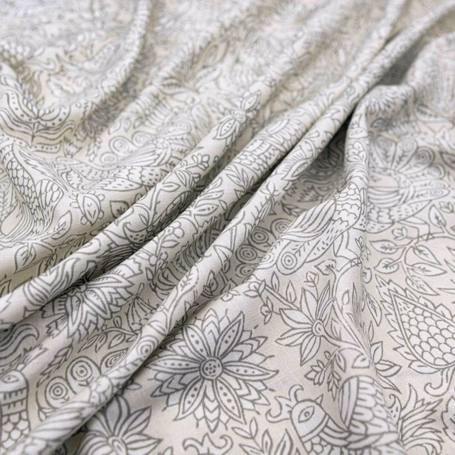 Pale putty fabric with grey botanical, floral and bird linework in soft folds