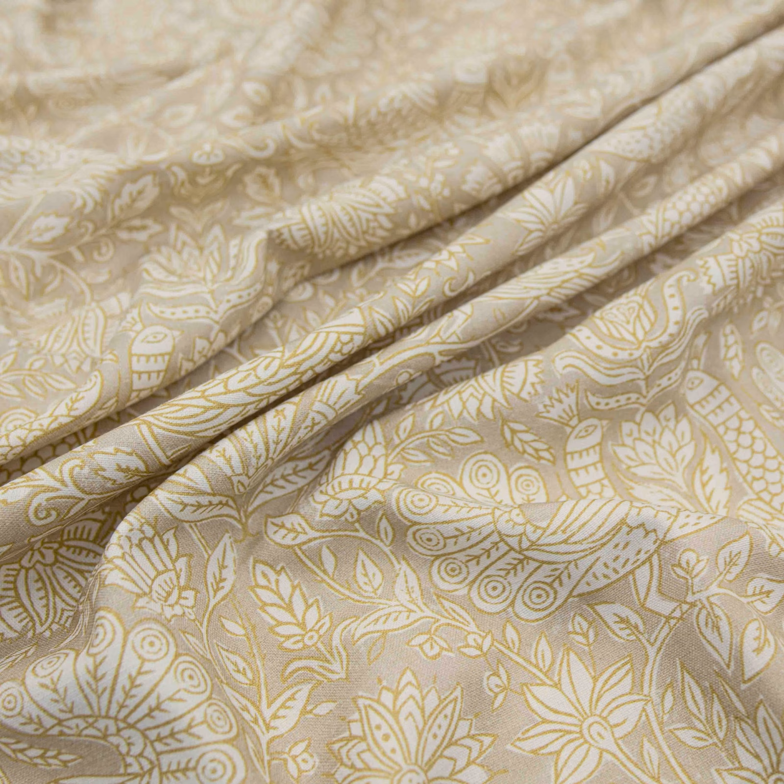 Pale stone fabric with muted saffron botanical paisley, leaves and softly folded cloth