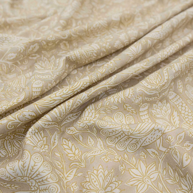 Pale stone fabric with muted saffron botanical paisley, leaves and softly folded cloth