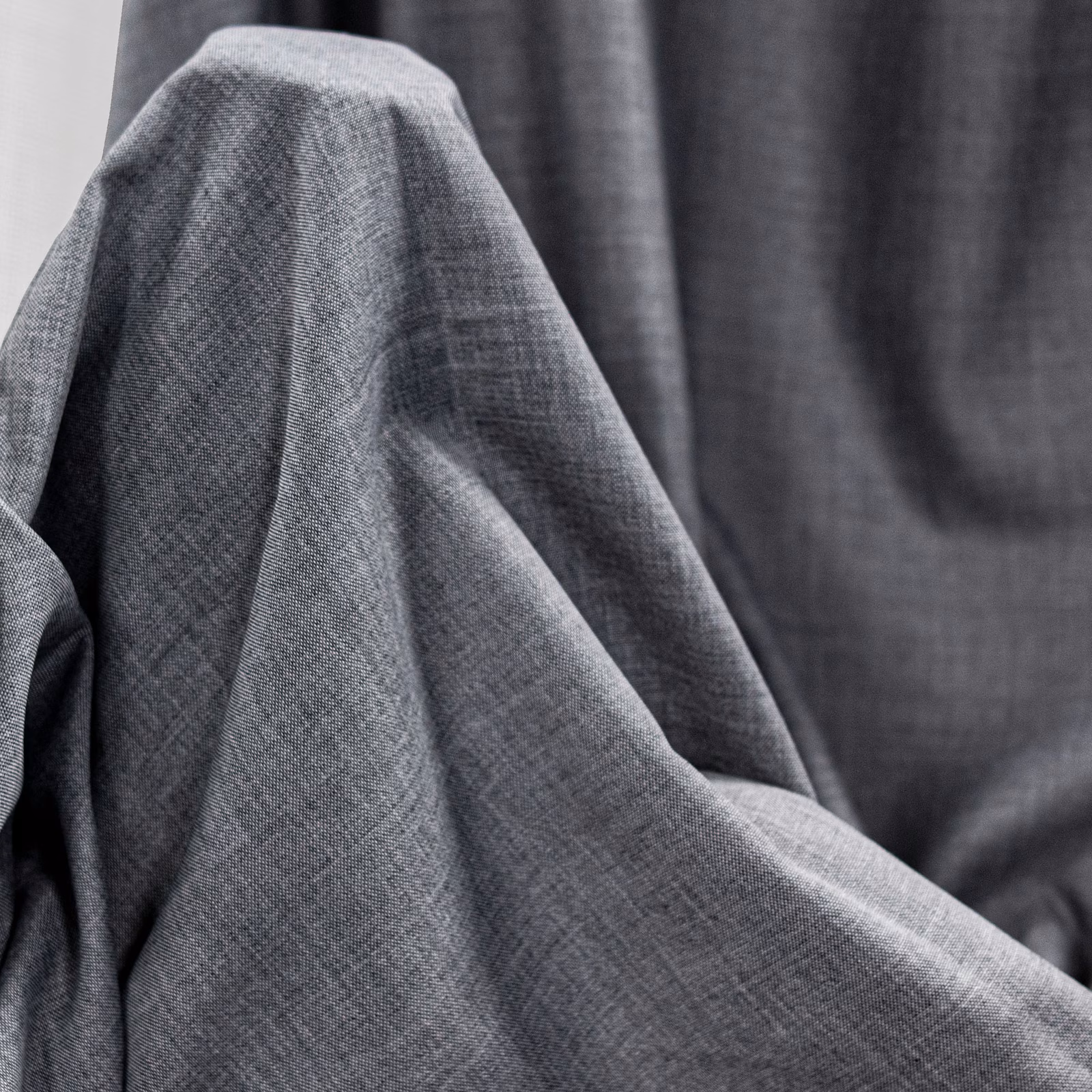 Charcoal-grey Pireas fabric with fine crosshatched weave and softly folded texture