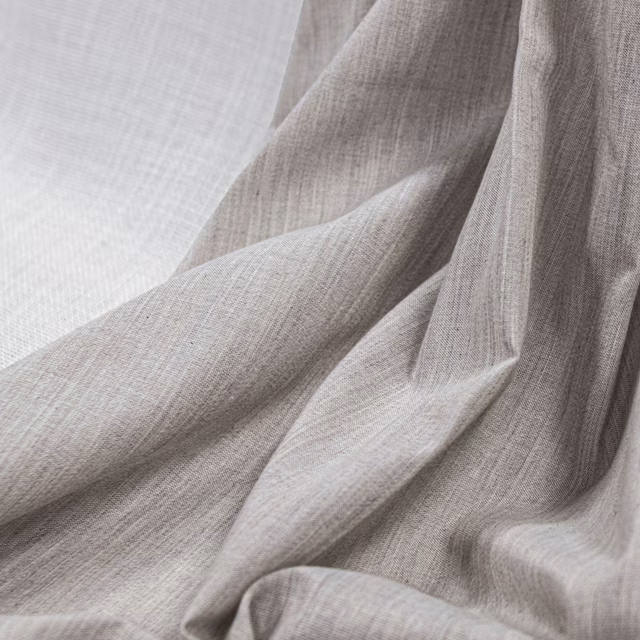 Warm greyed ecru fabric with fine plain weave arranged in soft folds
