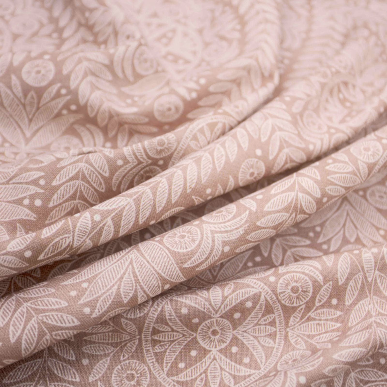 Dusty blush-pink fabric with cream leaves and rounded floral medallions
