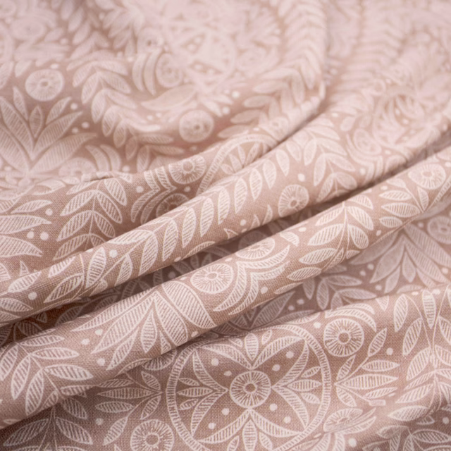 Dusty blush-pink fabric with cream leaves and rounded floral medallions
