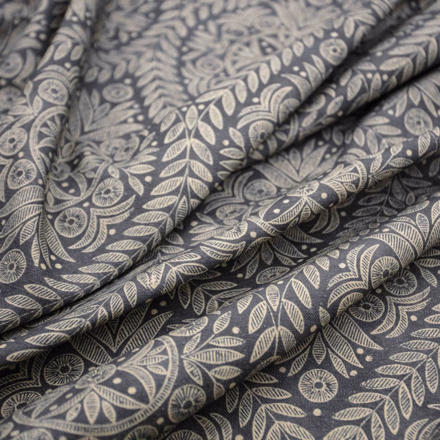Charcoal fabric with pale stone botanical leaves and stylised flowers in soft folds