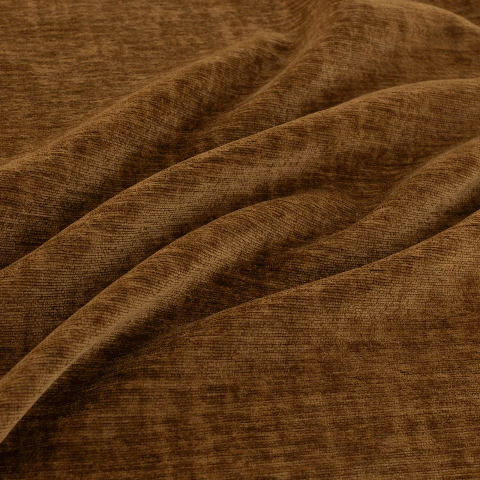 Warm cocoa-brown ribbed fabric draped in broad folds with softly catching highlights