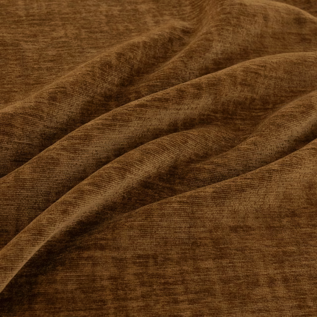 Warm cocoa-brown ribbed fabric draped in broad folds with softly catching highlights