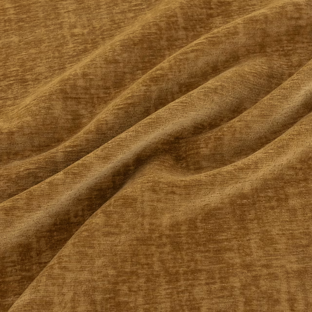 Warm saffron-ochre fabric with plush directional pile and caramel-brown shading