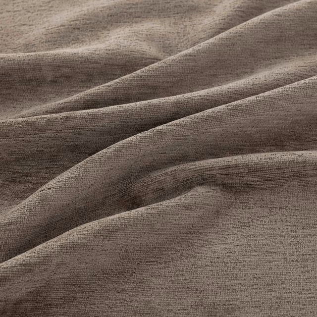 Warm truffle-brown crosshatched weave gathered into softly lit, deep fabric folds