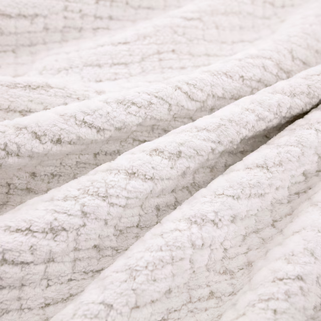 Plush snow-white upholstery with pale grey flecks and a raised nubby texture