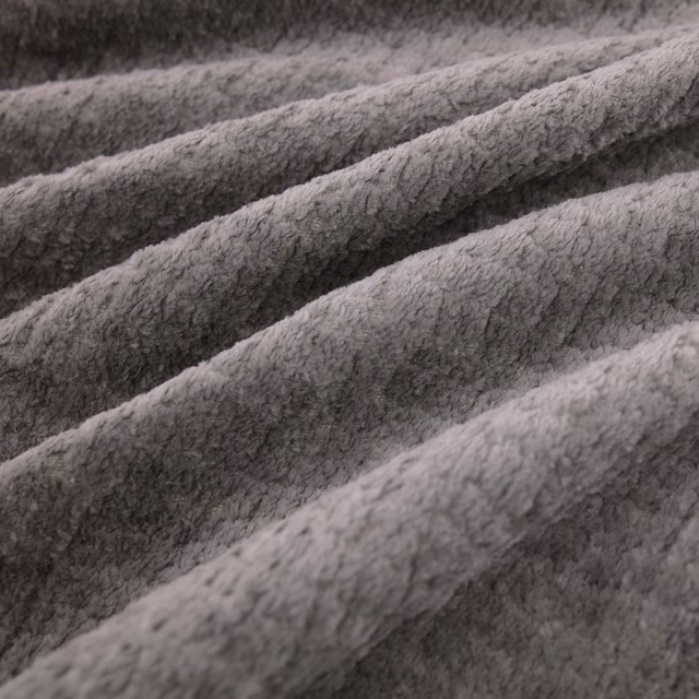 Close-up of Pucci Thunder’s cool grey plush pile forming deep diagonal ridges
