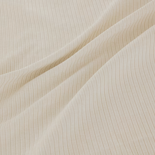 Pale cream fabric with fine wavy vertical striations across overlapping folds