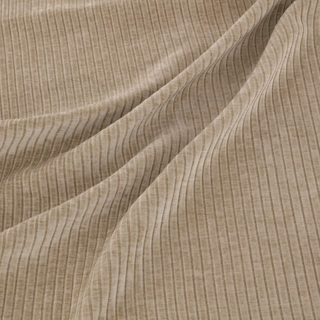 Warm taupe fabric with fine vertical ribbing falling into soft diagonal folds
