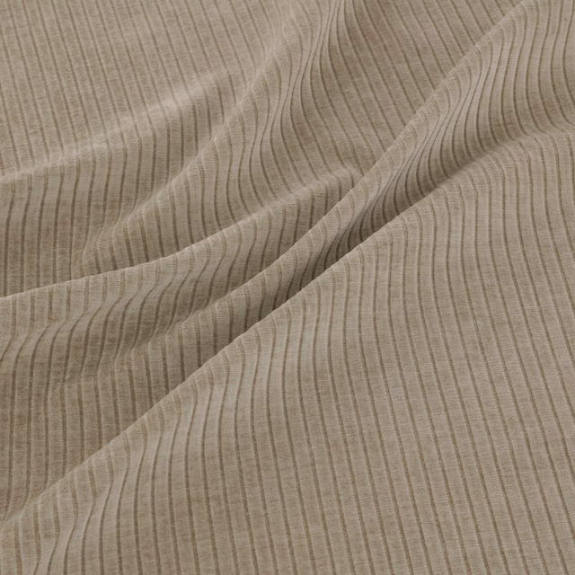 Warm taupe fabric with fine vertical ripples and softly folded texture