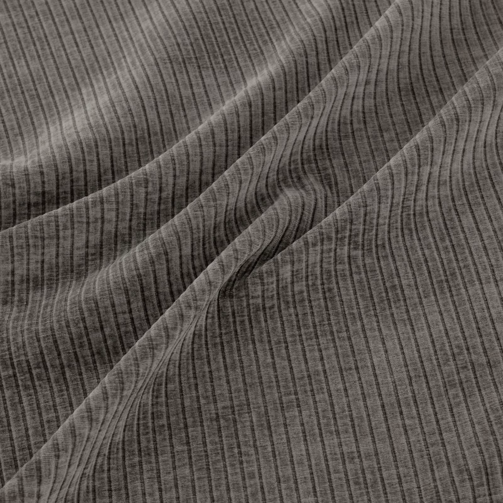 Muted plum-grey woven textile with fine vertical striations and diagonal draped folds.