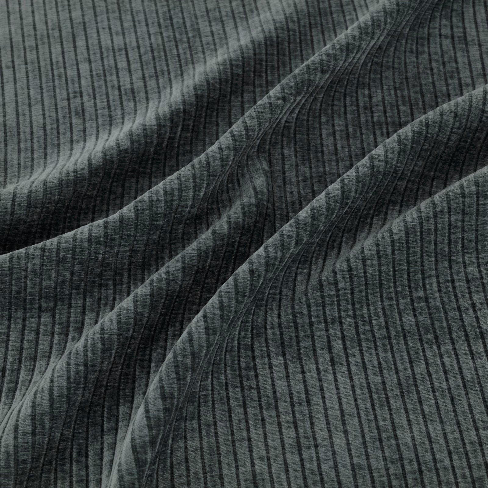 Deep teal ribbed fabric with fine vertical lines and sweeping curved bands