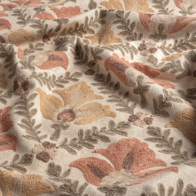 Cream textile with clay blooms, olive foliage and softly raised woven texture