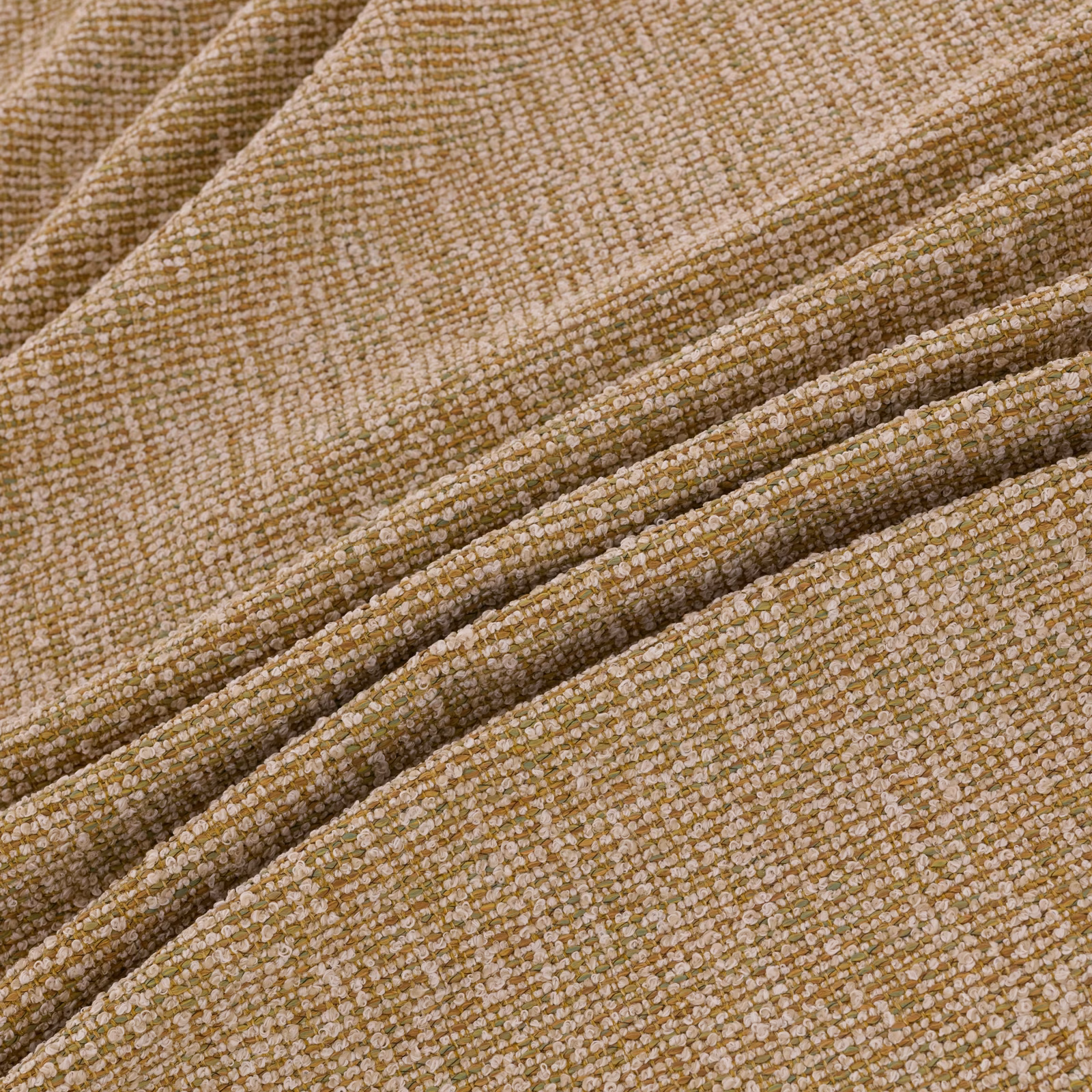 Warm amber-beige woven textile with nubby loops and folded ridges