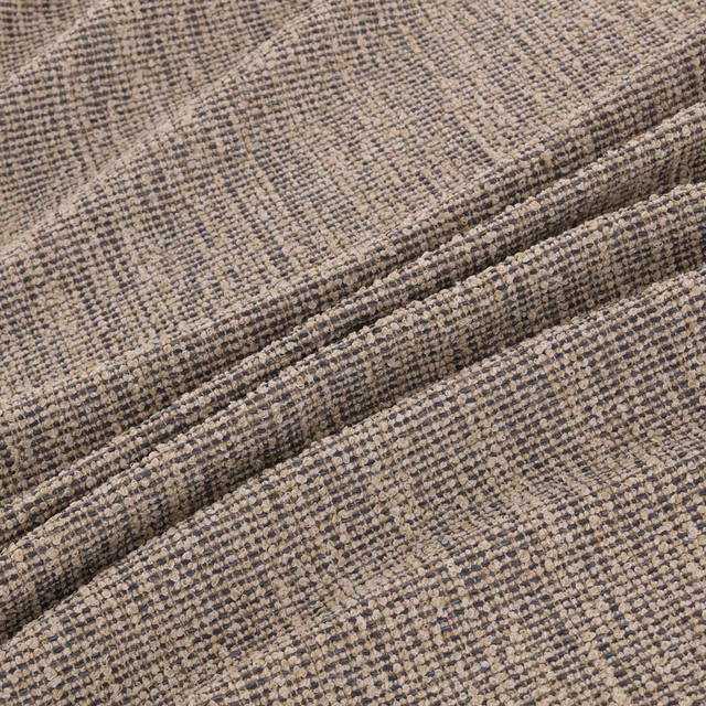 Close-up of warm greige Rimini fabric with charcoal flecks and nubby woven texture