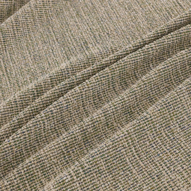 Muted sage-green, beige and grey woven textile shown in softly rippled folds
