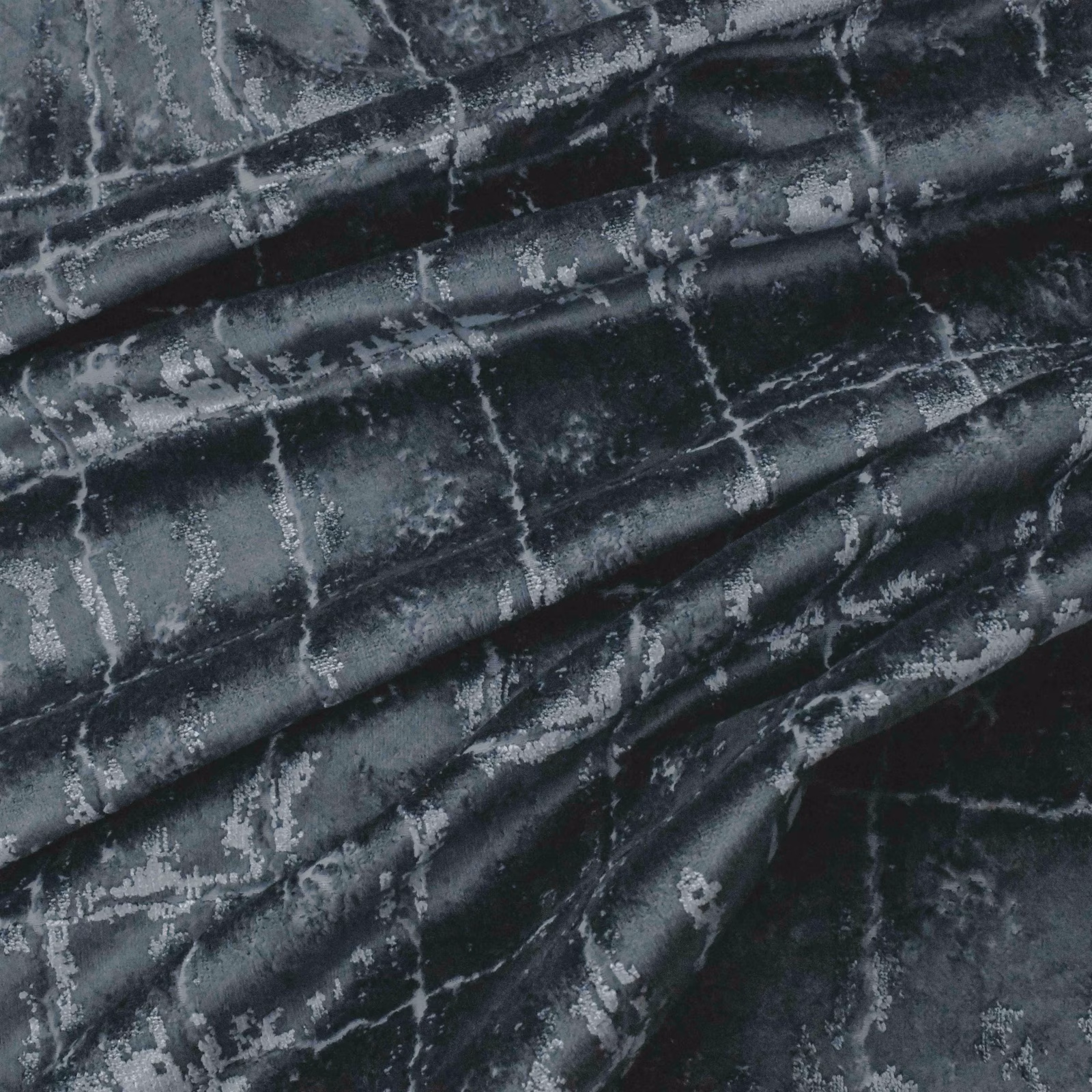 Dark petrol fabric with silver-grey distressed markings and glossy gathered folds