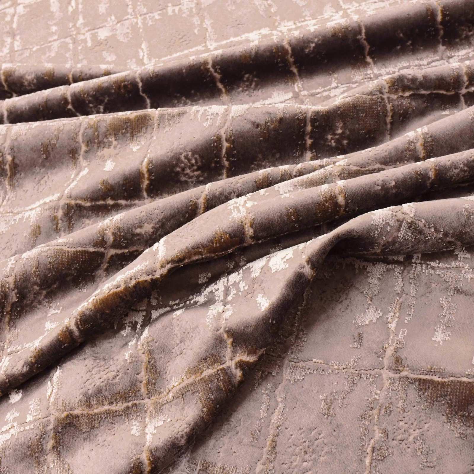 Folded rose-gold plush textile with chocolate bands and distressed pale metallic marks