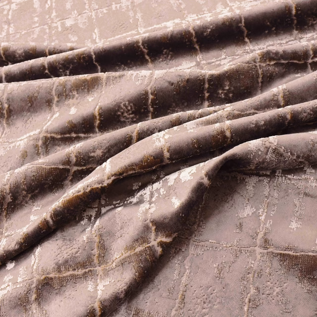 Folded rose-gold plush textile with chocolate bands and distressed pale metallic marks