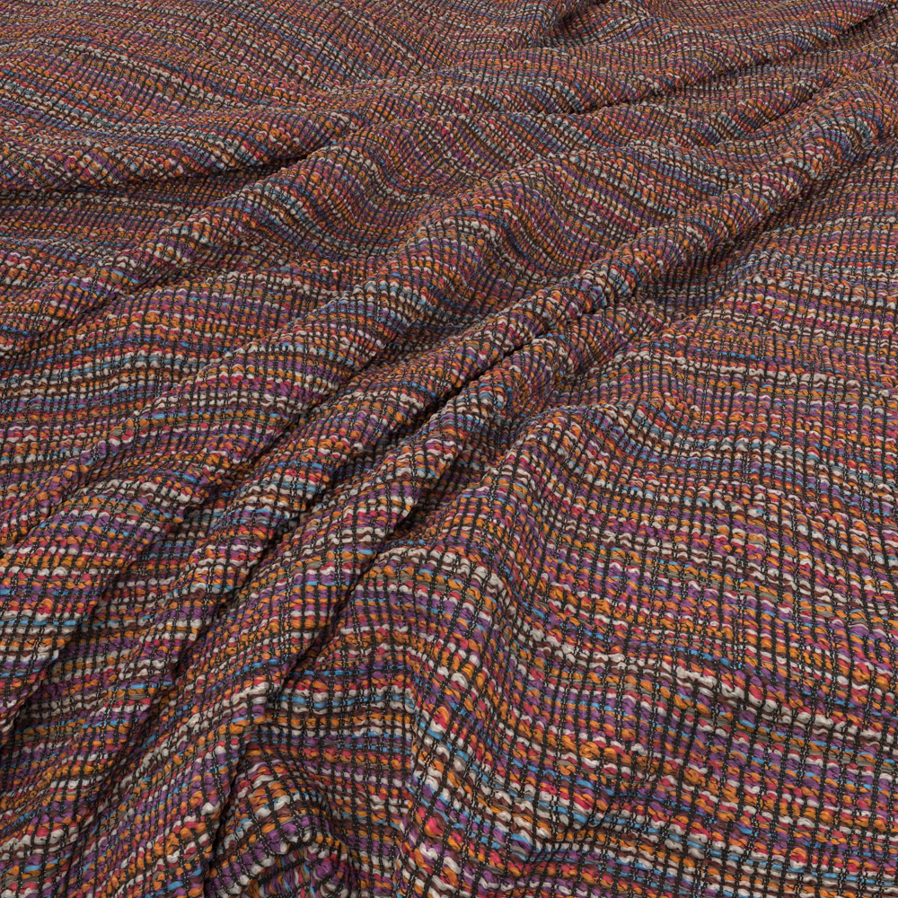 Plum and rust woven fabric with blue flecks and rippling textured lines